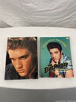 Two Elvis Presley coffee table books side by side. One titled 'Solid Gold Memories: The Elvis Presley Scrapbook'.