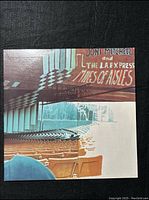 Front cover of the album showing Joni Mitchell and The LA Express "Miles of Aisles" with empty theater seats and stage