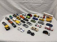 Front view of all toy cars arranged in rows showing color and model variety