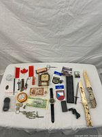 Full overview of all items laid on white cloth showing entire contents of the lot