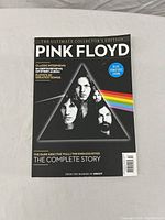Front cover of Pink Floyd Ultimate Collector's Edition book with iconic prism and band member images.