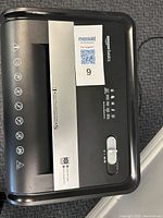 Top view of the shredder showing the AmazonBasics brand, control switch, and labeling indicating 18 sheet capacity.