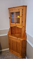 Full view of solid pine corner cabinet showing overall condition and design.
