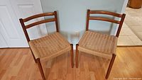 Both teak chairs side by side showing overall condition and style