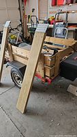 Pair of wooden loading ramp leaning against trailer