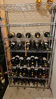 Full view of stainless steel wine rack with multiple wine bottles stored horizontally.