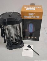 Front angle of the 360° Bug Zapper Pro mosquito killer showing the device, cleaning brush, user manual, and box.