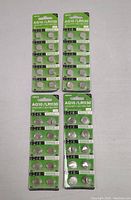 Four packs of ten AG10/LR1130 alkaline button cell batteries each, arranged on a surface.