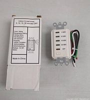 Photo of one white indoor in-wall timer with original box showing specifications: 120V 60Hz, 15A resistive, 1000W tungsten, 1000VA ballast, 500VA electronic ballast, 1/4 HP motor. Timer has labeled buttons for 5, 10, 15, 30 mins OFF and wiring attached.