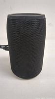 Front view of cylindrical black MusiBaby Bluetooth speaker with textured mesh surface.