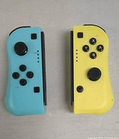 Front view of Nintendo Switch Joy-Con controllers showing the blue left controller with directional buttons and thumbstick and yellow right controller with action buttons and thumbstick.