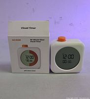 Front view of visual timer and box showing digital display and color-coded segment with orange button on top