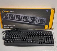 Blackweb wired USB keyboard with cable and retail box showing front and sides, new open box condition.