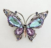 Front view of butterfly brooch showing blue and purple crystals and silver-tone metal