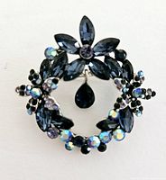 Front view showing the detailed blue marquise and round beads arranged in a floral wreath with a dangling teardrop bead.