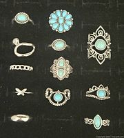 Lot of 12 pre-owned Southwest style fashion rings featuring turquoise-colored stones and silver-tone metal, shown in two similar images from top down.