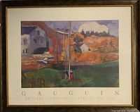 Framed art print of 'Gauguin Brittany Landscape' showing houses by water, trees with fall tones and sailboat.