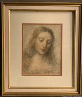 Front view of framed portrait print showing detailed Leonardo Da Vinci style head and shoulders drawing of a woman, matted and in gold frame.
