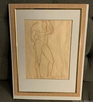Framed pencil sketch showing the nude male figure from the front with one arm bent and hand near chin.