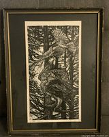 Framed black and white print depicting birds in trees, with visible frame and matte border.