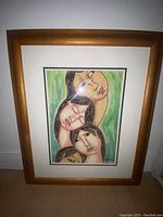 Framed original painting by Gamez showing four stylized female faces with a green background. Visible signature on lower right.