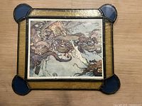 Full front view of the signed Gamez original painting showing elaborate fantasy artwork and ornamental stained glass frame.