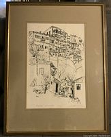 Photo showing a framed black ink sketch of buildings on hillside, signed with initials O.K.