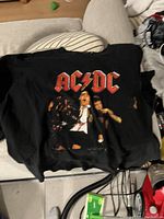 Black short-sleeve t-shirt with red AC/DC logo and band graphic