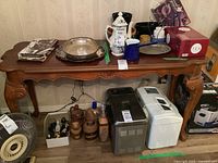 Full view of console table showing maple wood surface with various items on top and underneath but not included in sale.