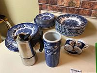 Overall view of Staffordshire dinnerware, Bialetti espresso maker, espresso cups and saucers, tall vase