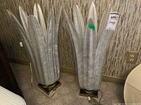 Front view of both lamps showing leaf-like panels and gold-tone bases.