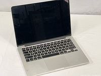 Front view of the Apple MacBook Pro A1502 laptop with screen open, showing the keyboard and display area off.