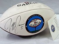 Side view of white football showing the printed Jeff Garcia Open 2004 logo and signature.