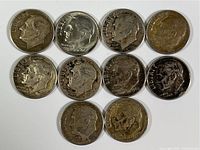 Obverse side view showing profile portraits of Franklin D. Roosevelt on all ten silver dimes, dates visible on some coins including 1950, 1951, and 1952, varying wear and patina.