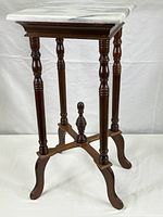 Full view of marble plant or lamp stand showing square marble top and mahogany wood turned legs with central finial stretcher.