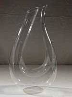 Full front view of U-shaped dual-spout decanter on white surface