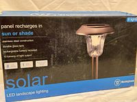 Box front showing brand Westinghouse, solar LED landscape lighting kit with 8 lights and features.