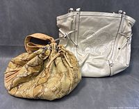 Both bags shown side by side on a neutral grey surface, highlighting size and shape difference.