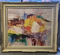 Full front view of framed abstract oil painting with gold-tone wood frame