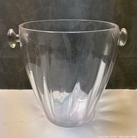 Clear view of the Guzzini champagne bucket from the front showing ribbed surface and round handles on each side
