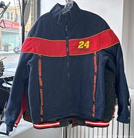 Front side of vintage reversible jacket showing navy blue exterior with red stripe, yellow 24, and Dupont Jeff Gordon branding.