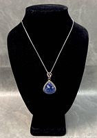 Full view of necklace displayed on black bust showing chain length and teardrop pendant