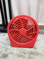 Front view of the red 6-inch mini desk fan showing circular grille and blades