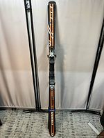 Full view of one Voiki P40 RC ski, 178cm with bindings attached, showing black and orange color scheme with white accents.