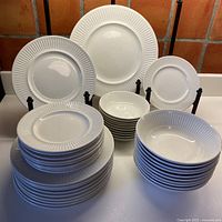 Full view of stacked plates and bowls showing total piece count