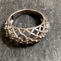 Top angled view showing the woven design and tiny spheres at intersections on the sterling silver ring.
