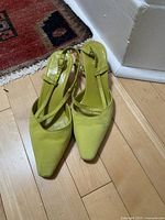 Top view of both lime green suede sling-back shoes showing double front straps and pointed toes.