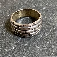 Angle showing the ring standing upright to highlight the raised rectangular brick tile pattern.