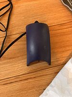 Blue casing of Whisper 10 air pump with black underside showing model and electrical info