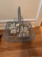 Wire basket with decorative handle sitting on wooden floor